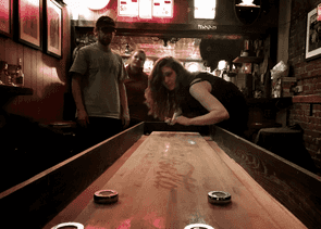 Person playing a game at a bar